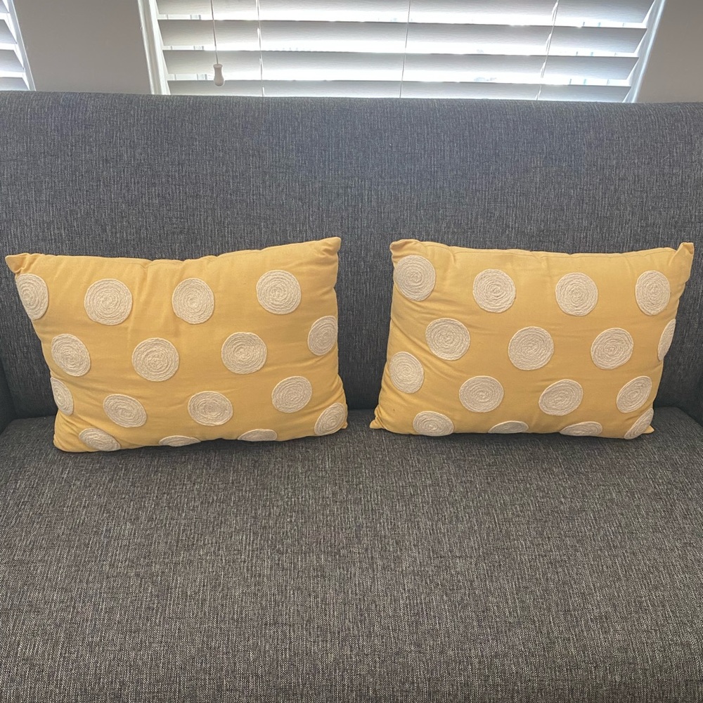 Set of two yellow throw pillows